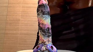 Busty ebony slut stains the camera squirting as she rides a dildo