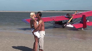 Tanned blonde works cock by the beach in fantastic positions