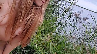 Outdoor solo masturbation scene with curly blonde