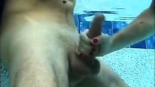 Funny handjob inside swimming pool