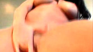 A super sexy brunette massages her big boobs