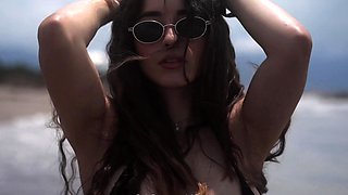 Sexy Latina MILF in bikini posing seductively on the beach