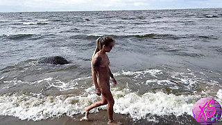 Beauty blonde walking naked on the seashore