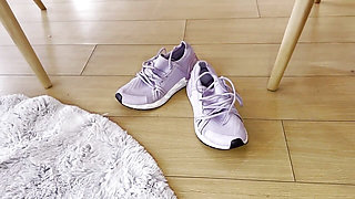 A Woman Warms up After the Gym by Touching Her Sweaty Feet