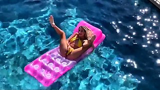 a beautiful blonde masturbates in the pool and lures a