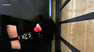 Gagged and Hooded Slave struggles in Straitjacket While In Cage