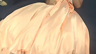 Enjoying a cuteute pink satin prom dress in bed