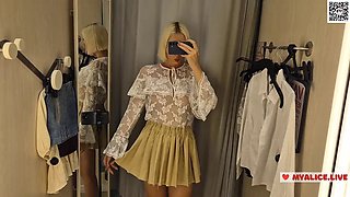 Trying on transparent clothes in the fitting room. Naked blonde flashed her boobs in a public place