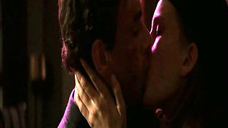 Natasha Henstridge making out with a guy in a bathroom as