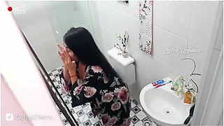 Peeking through the bathroom door as she changes
