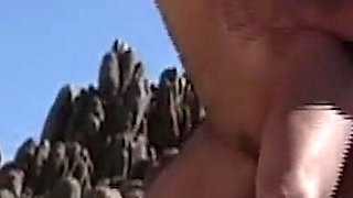 She Lies Naked on the Beach While He Watches Her