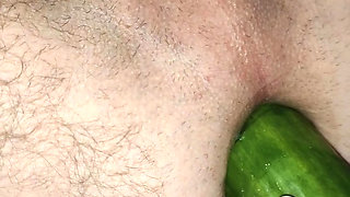 My wife is fucking my ass with a huge cucumber.