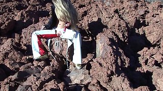Outdoor solo masturbation scene with curly blonde