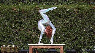 Bending in a Silver Spandex Suit