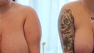 Two Busty MILFs Play with Each Other and Pour Milk Over Each Other's Bodies in the Bathtub.