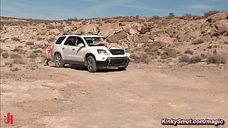Man torments busty tits babes in a desert