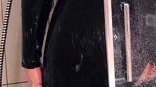 Wet MILF washing in latex rubber catsuit, pussy ass tease
