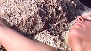 Lustful blonde Kelly Trump masturbates on rocks