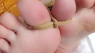 First-person Perspective Records the Girlfriend Wrapped in Tape From Head to Toe with Her Beautiful Bare Feet