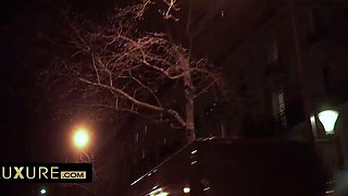 Two studs share a dark-hued doll in a car