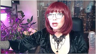 Mature woman pleasures herself with a see-through dildo