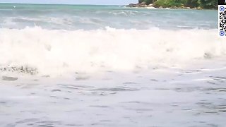 Brown haired girl taunts on a sunny beach
