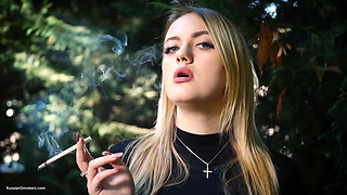 Hot Blonde Babe Smoking One Black Cigarettes in Nature