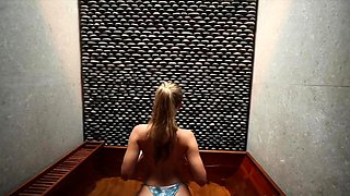 Blonde MILF housewife posing in bikini in the bathroom