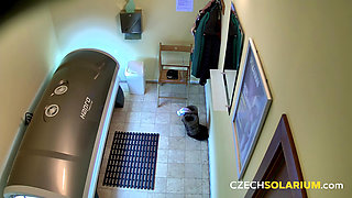 Czech Solarium 40: Brunette Flashes Her Pussy with a Naughty Smile