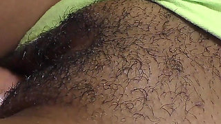 Close-up of a black hairy cunt filled with hot jizz