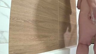Bathroom spy cam captures plump MILF with big natural tits showering and fingering her hairy pussy - PAWG amateur homemade