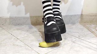 Punk kicking a banana under her footwear